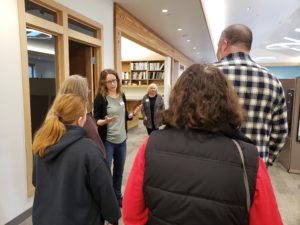 WeedWise Specialist Lindsey Karr leads a tour of the staff offices and work room.