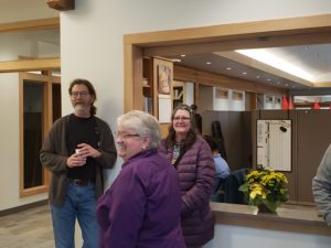 Board Chair Becker and Office Manager Tami Guttridge enjoy conversation at the reception desk.