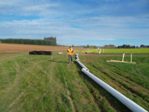 New irrigation mainline being laid along field.